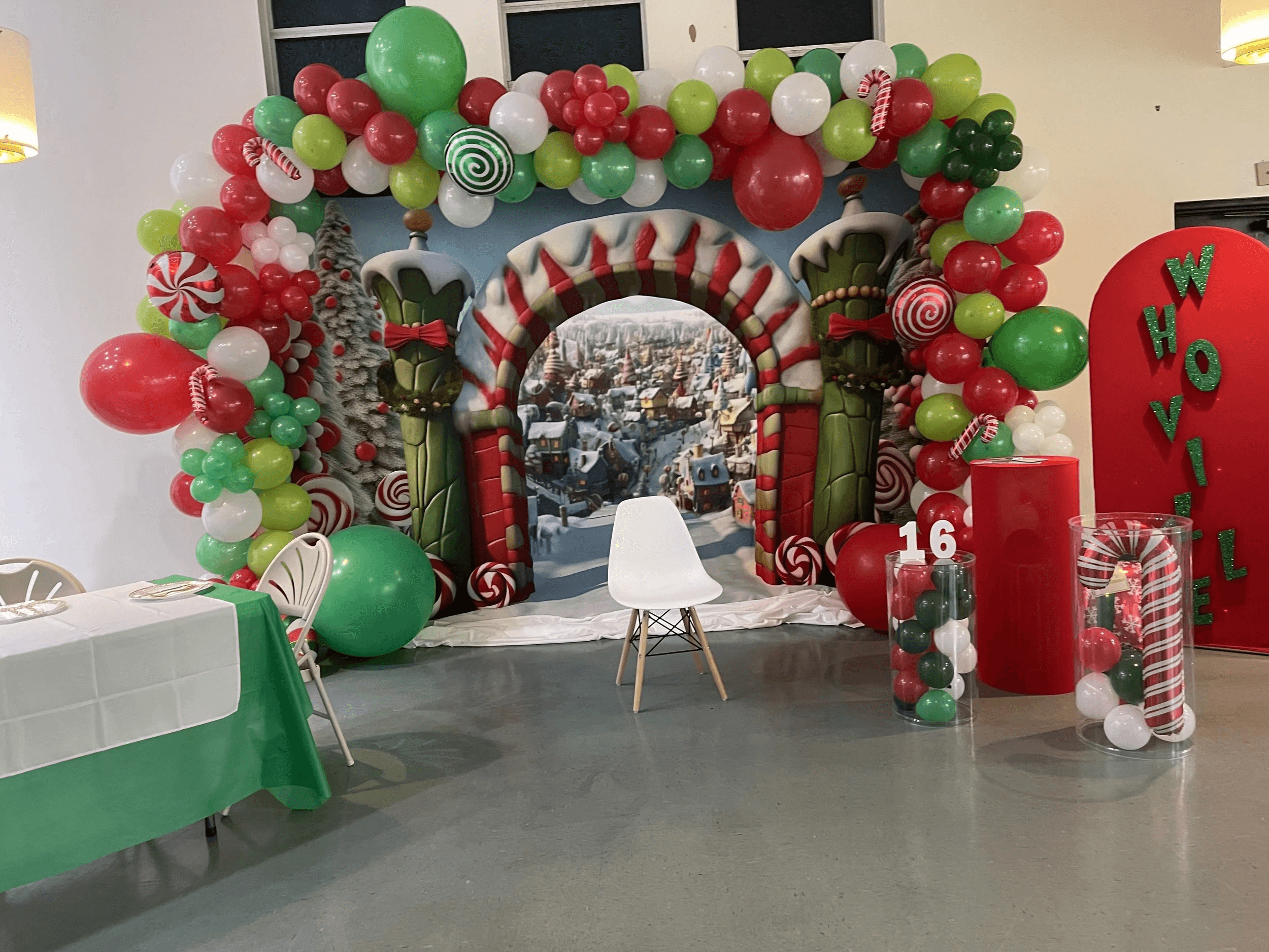 Whoville-themed Christmas balloon arch installation for a Sweet 16 party