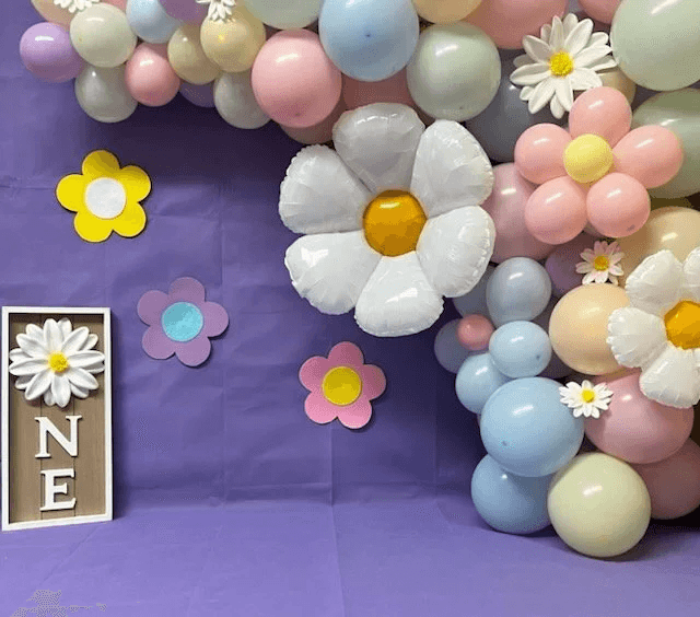 Pastel boho daisy first birthday balloon installation